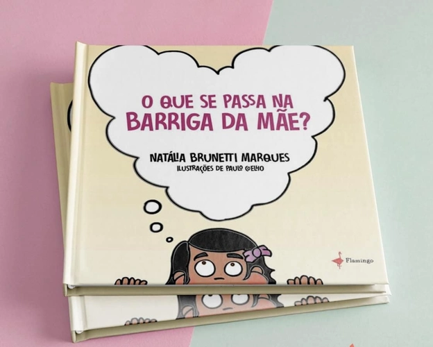 Capa do livro infantil "O que se passa na barriga da mãe?", de Natália Brunetti Marques, com ilustrações de Paulo Coelho. A capa mostra uma menina de olhos arregalados olhando para cima, com um grande balão de pensamento onde está escrito o título do livro. O fundo é em tons suaves e o livro está apoiado sobre uma superfície rosa e verde clara.